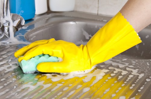 Cleaner dusting and polishing a living room during a Balham move-out clean